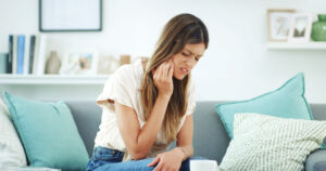 What causes gum infection around an implant tooth